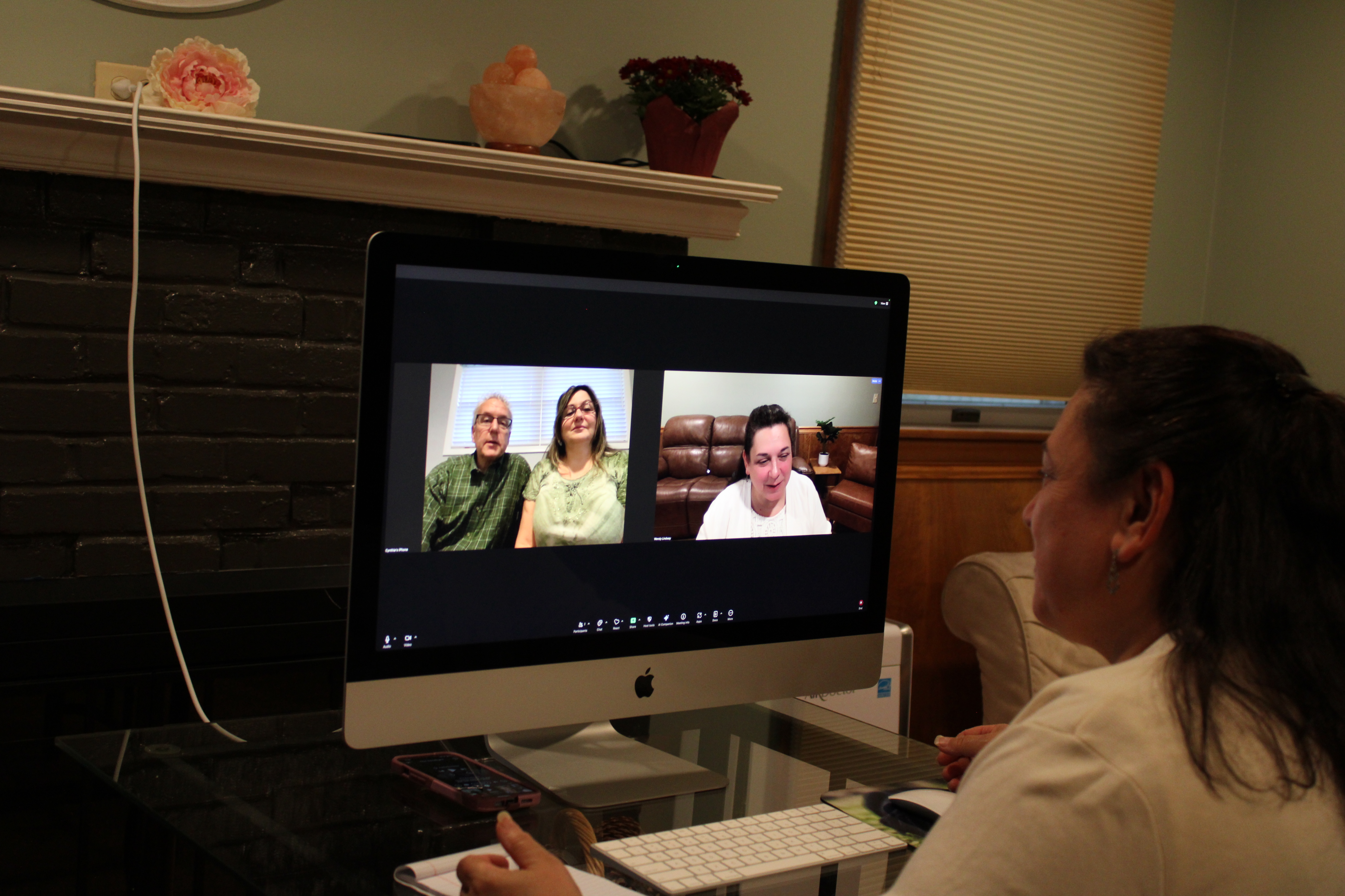 Doctor examines a young boy with his mother present.