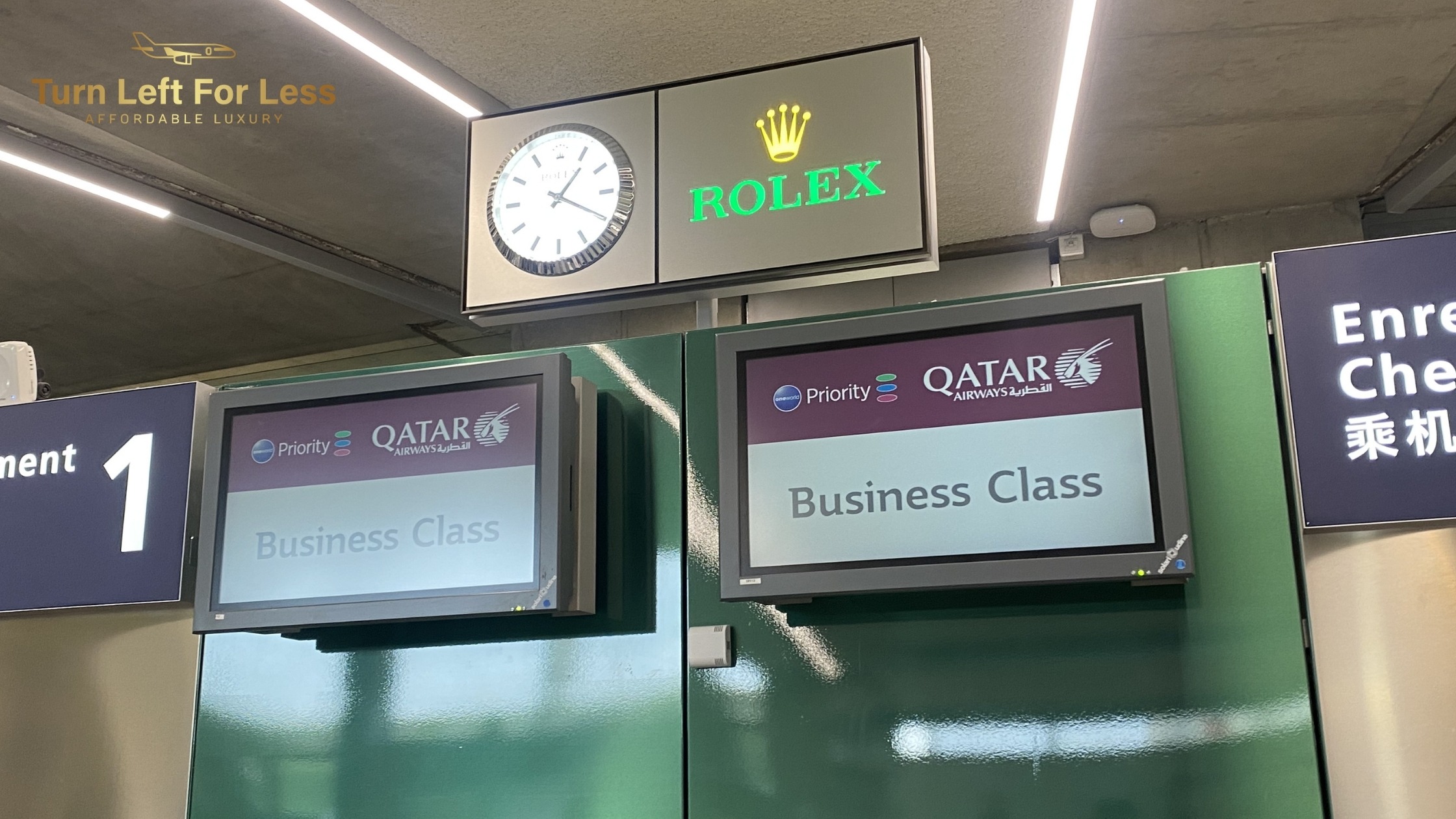 Qatar Airways business class check-in counters with Rolex clock at airport