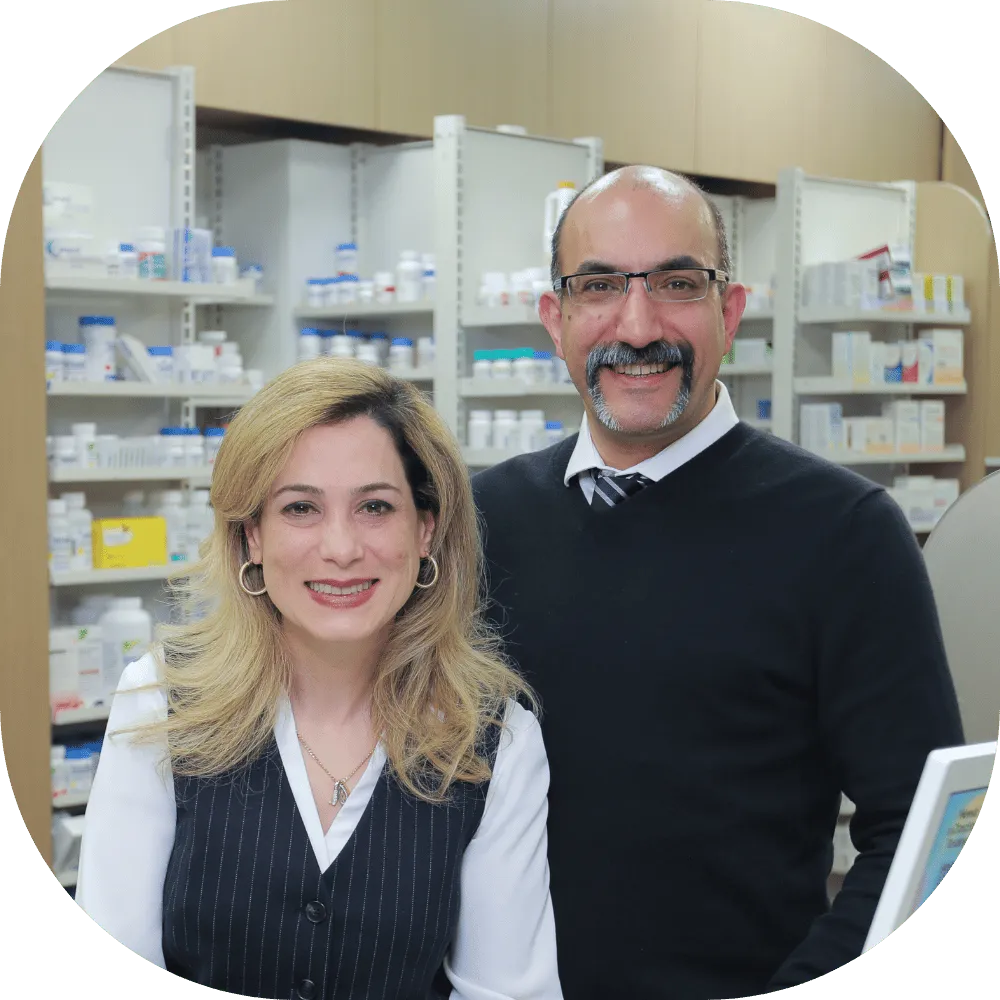 Brentwood Pharmacy in Burnaby pharmacists standing in front of the prescription and wellness section.