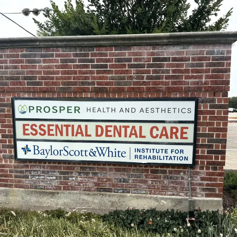 A multi-tenant red brick monument sign for Prosper Health and Aesthetics, Essential Dental Care, and Baylor Scott & White