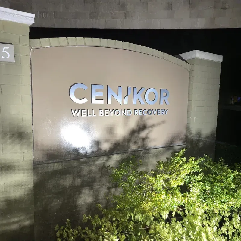 Modern stone monument sign for Cenikor Well Beyond Recovery surrounded by green landscaping