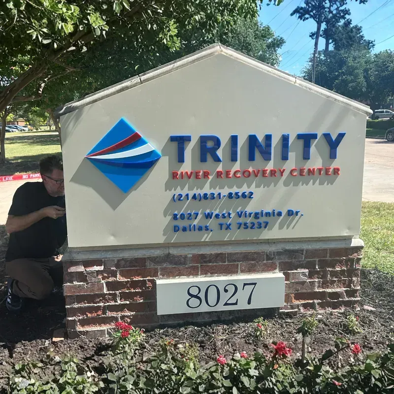 Commercial monument sign for Trinity Industries showing corporate logo and street address