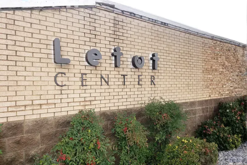 Non-illuminated channel letter building sign installed on commercial facade