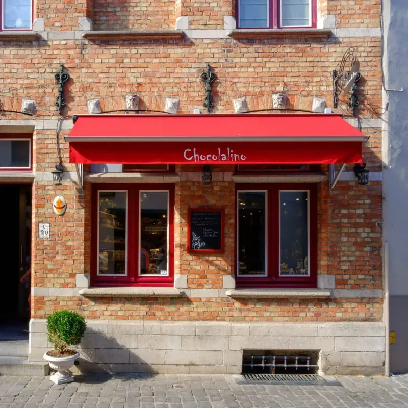 Classic red storefront awning with white lettering for an upscale Churrascaria restaurant
