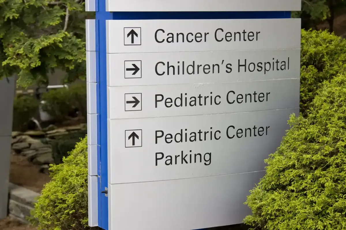 Professional blue and white directional pylon sign for a medical campus, including wayfinding for a Cancer Center and Children's Hospital