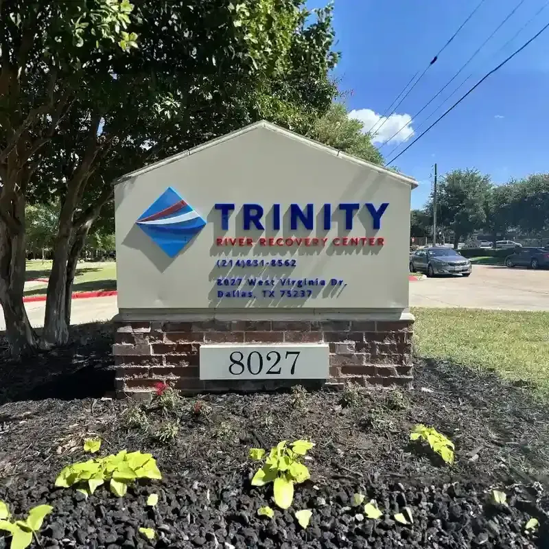 A modern brick and stone monument sign for Trinity Heart & Vascular Center with integrated landscaping and street address