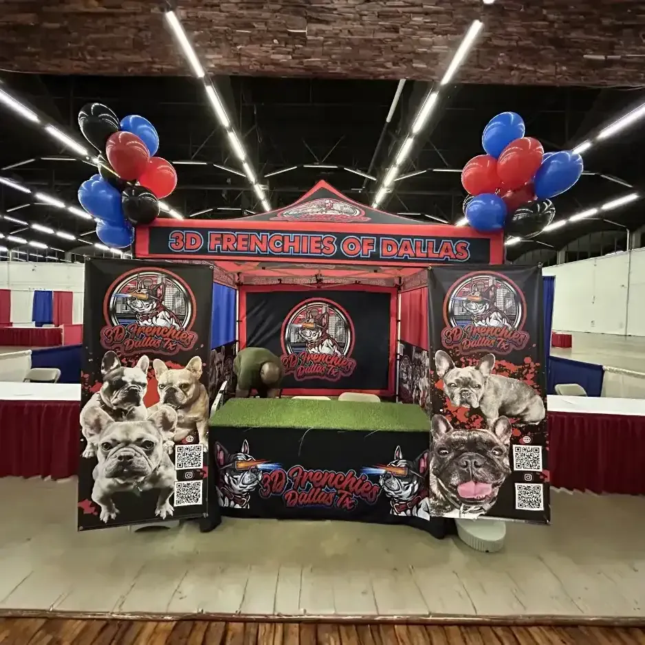 A complete custom tradeshow booth setup with a branded canopy, animal-themed backdrops, and patriotic balloon accents