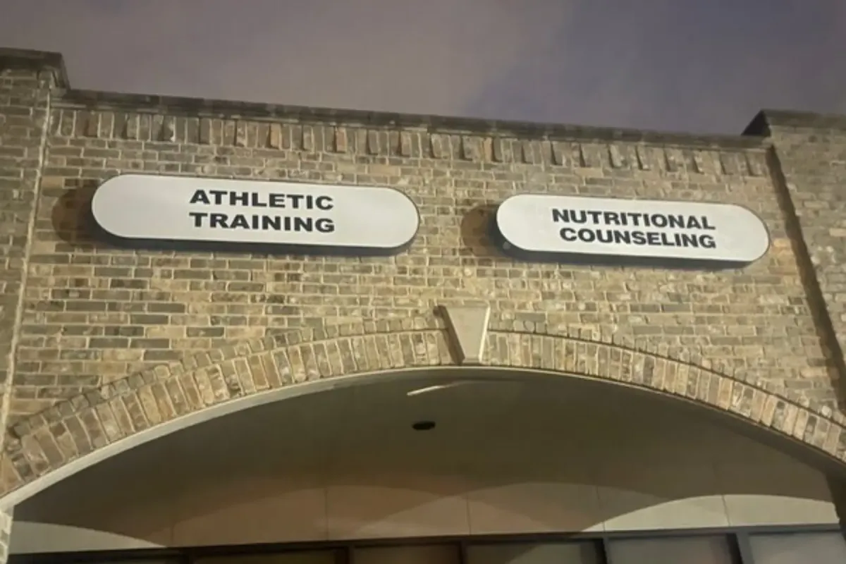 Commercial building signs for Athletic Training and Nutritional Counseling on a brick storefront.