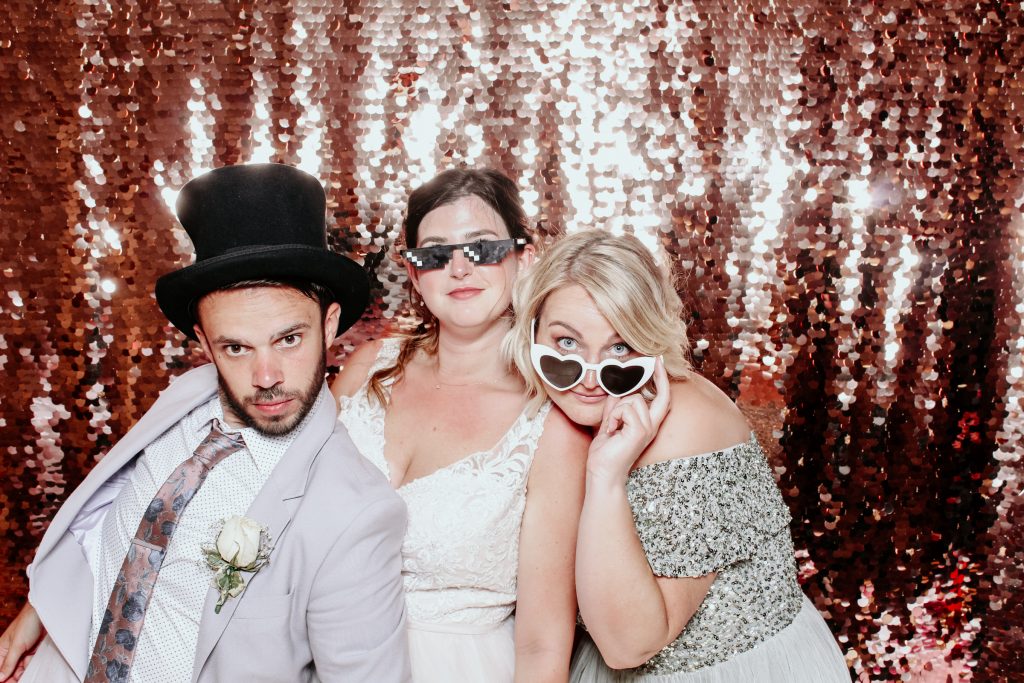 Guests using props inside luxury photo booth rental