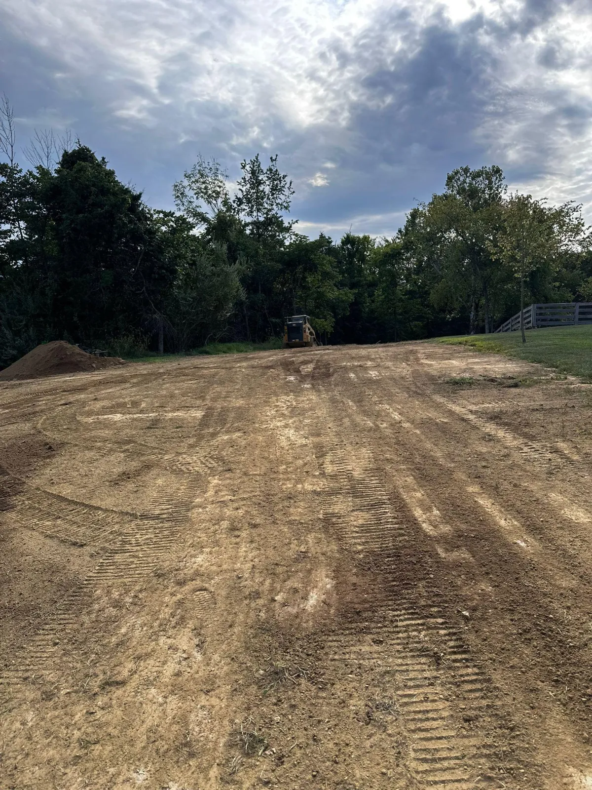 A close up of a rock with a wood fence in the background