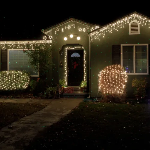piled hanging lighted bulb beside house