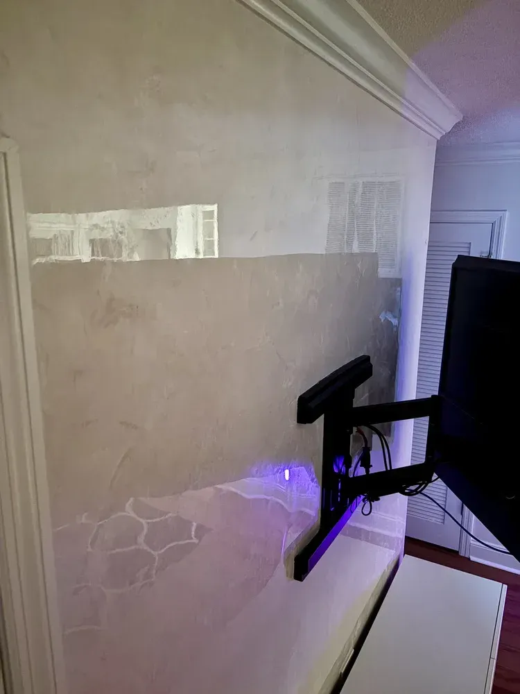 Custom Venetian plaster stairway wall with layered texture and reflective finish