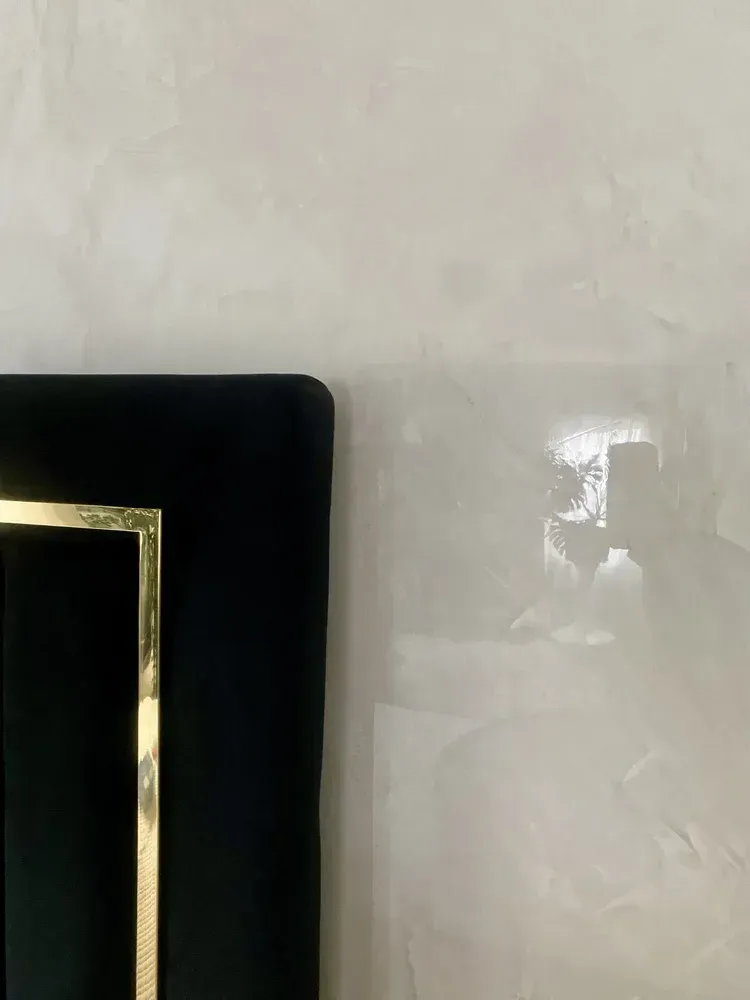 Close-up of polished Venetian plaster wall showing handcrafted movement and luminous reflection