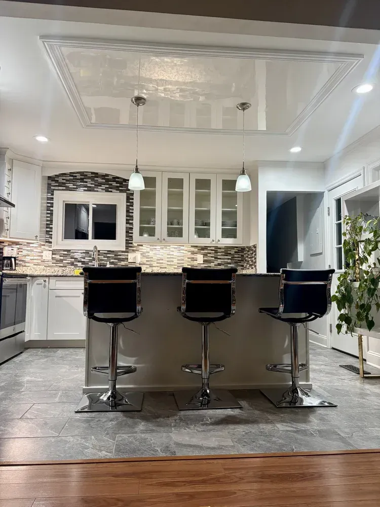 Mirror-polished Venetian plaster ceiling creating a reflective statement finish in a St. Louis kitchen