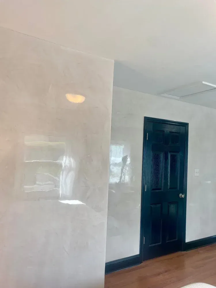 Light polished Venetian plaster entry wall with subtle movement and reflective finish in St. Louis