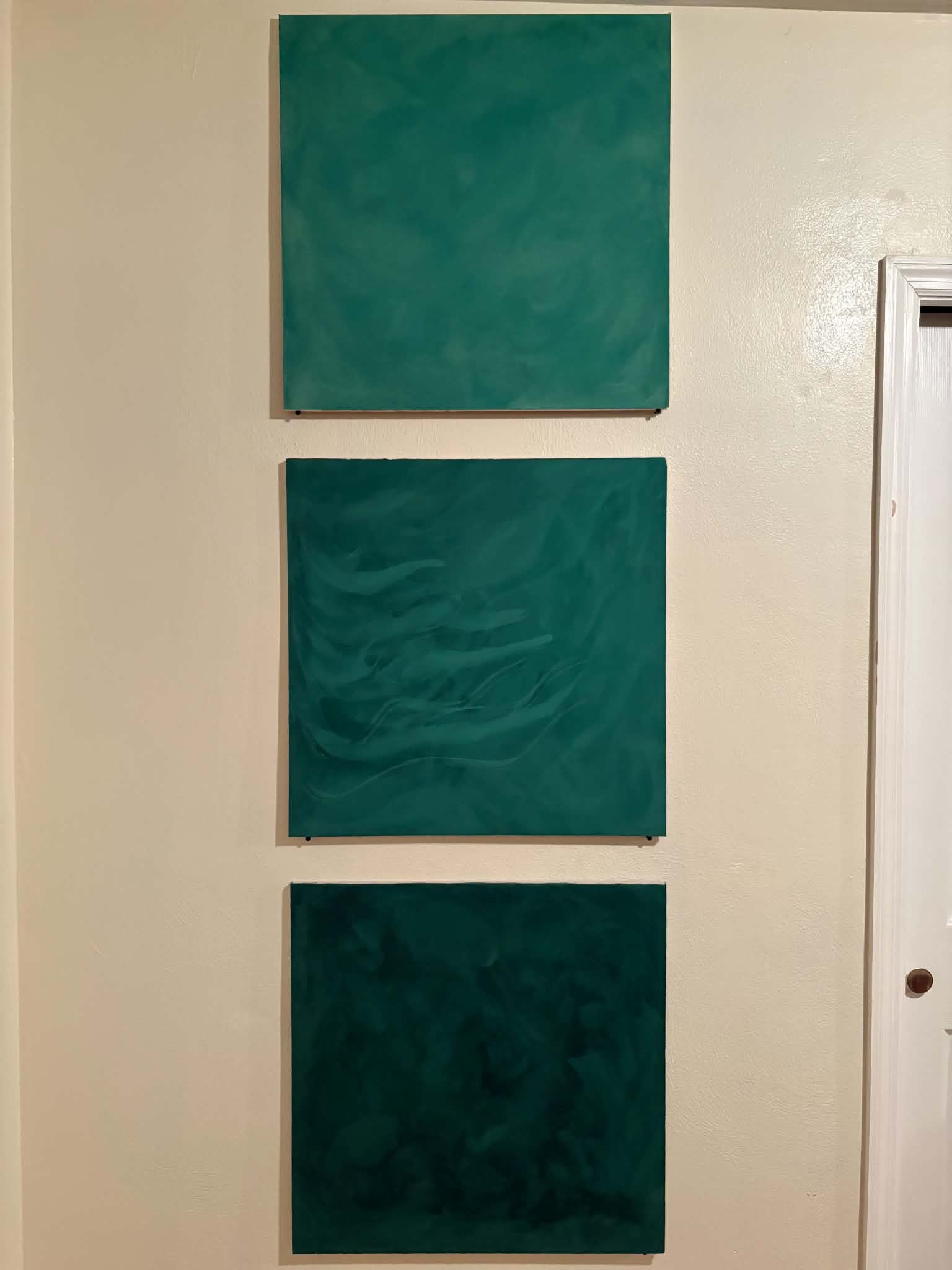 Custom green Venetian plaster sample panels showcasing variations in color, movement and finish