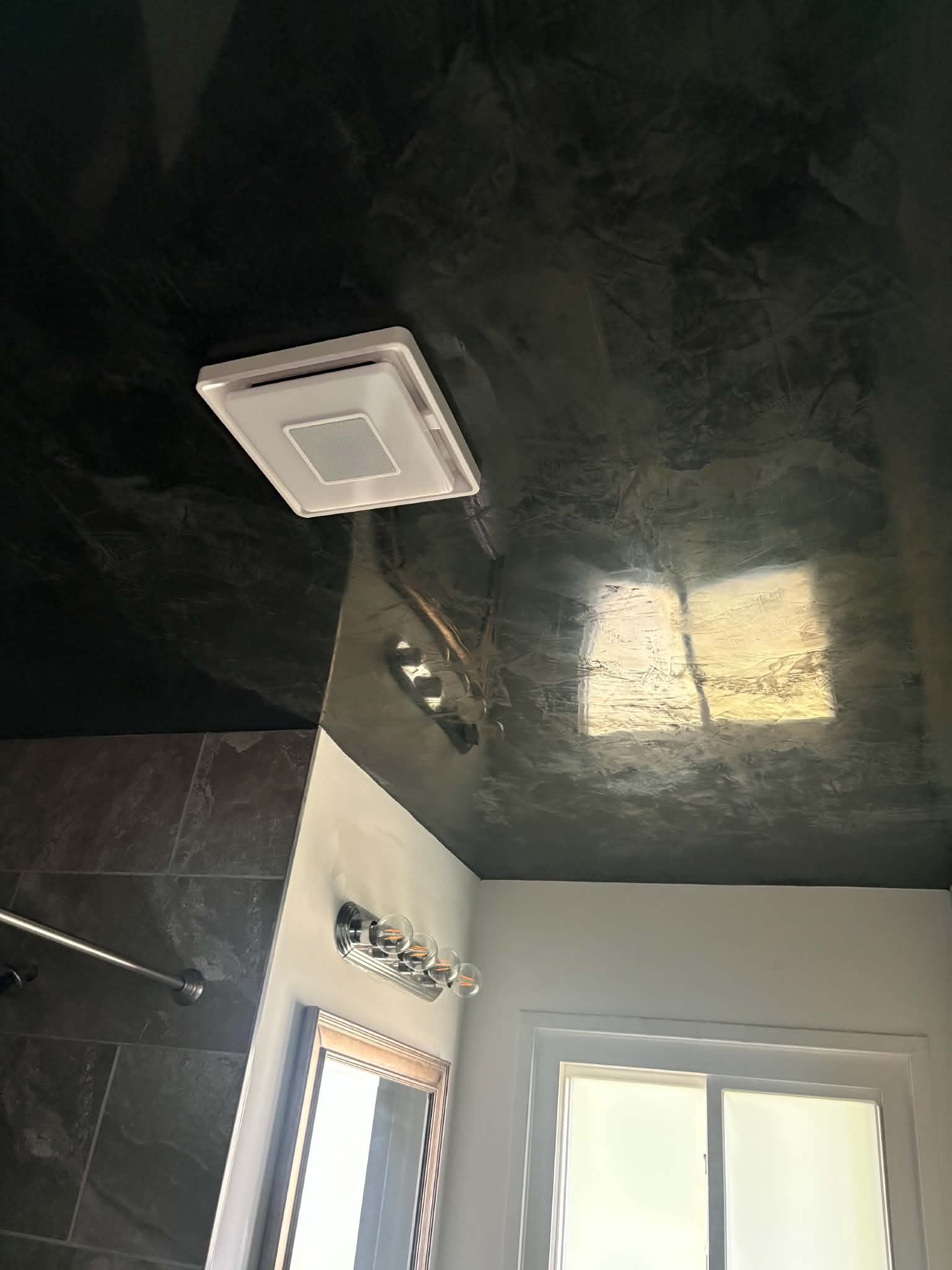 Dark polished Venetian plaster ceiling with high-gloss reflective finish in a St. Louis interior
