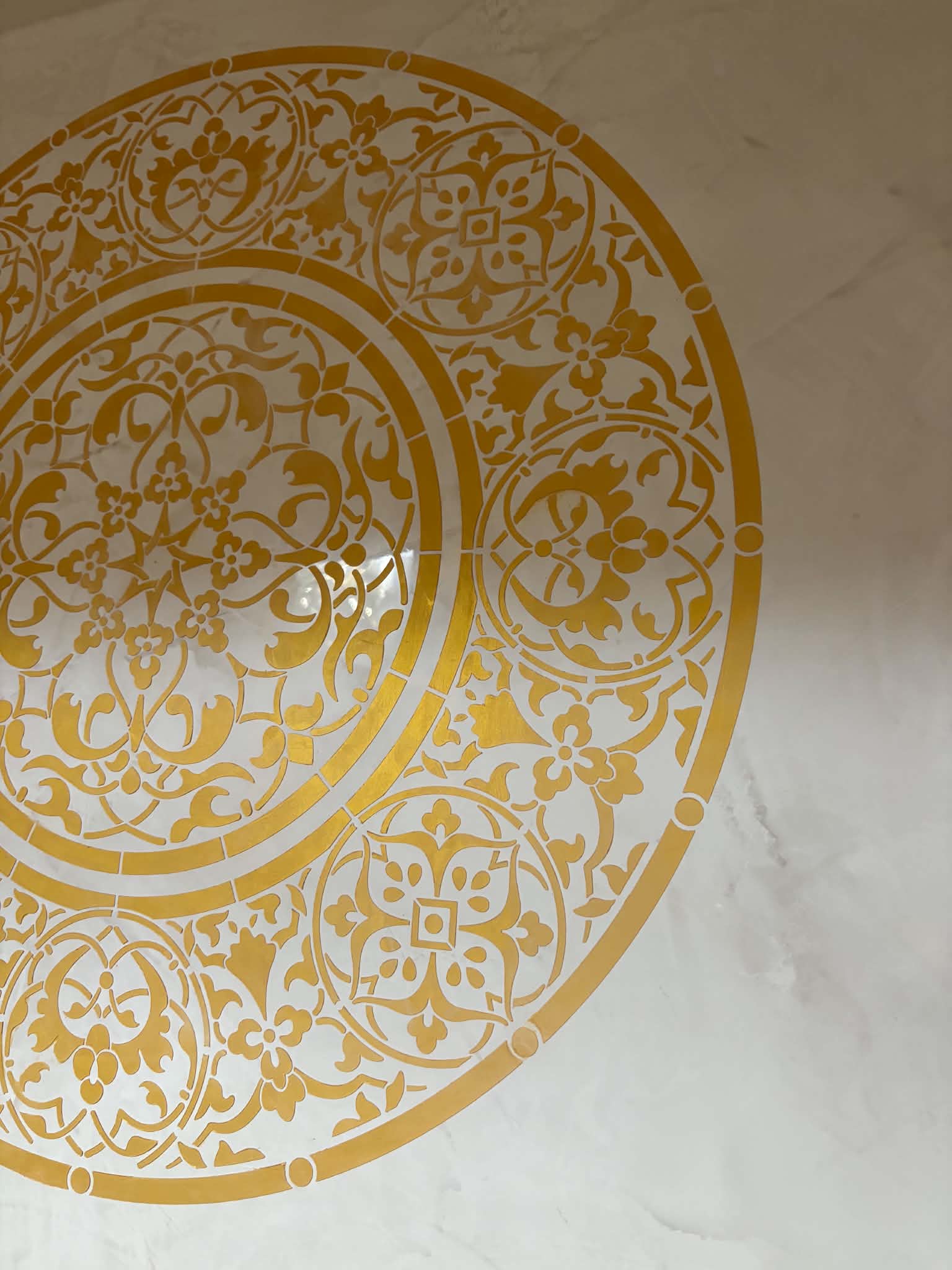 Custom gold decorative plaster medallion with intricate hand-applied detailing