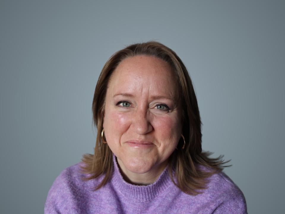 a person standing in front of a fence with a drawing on it