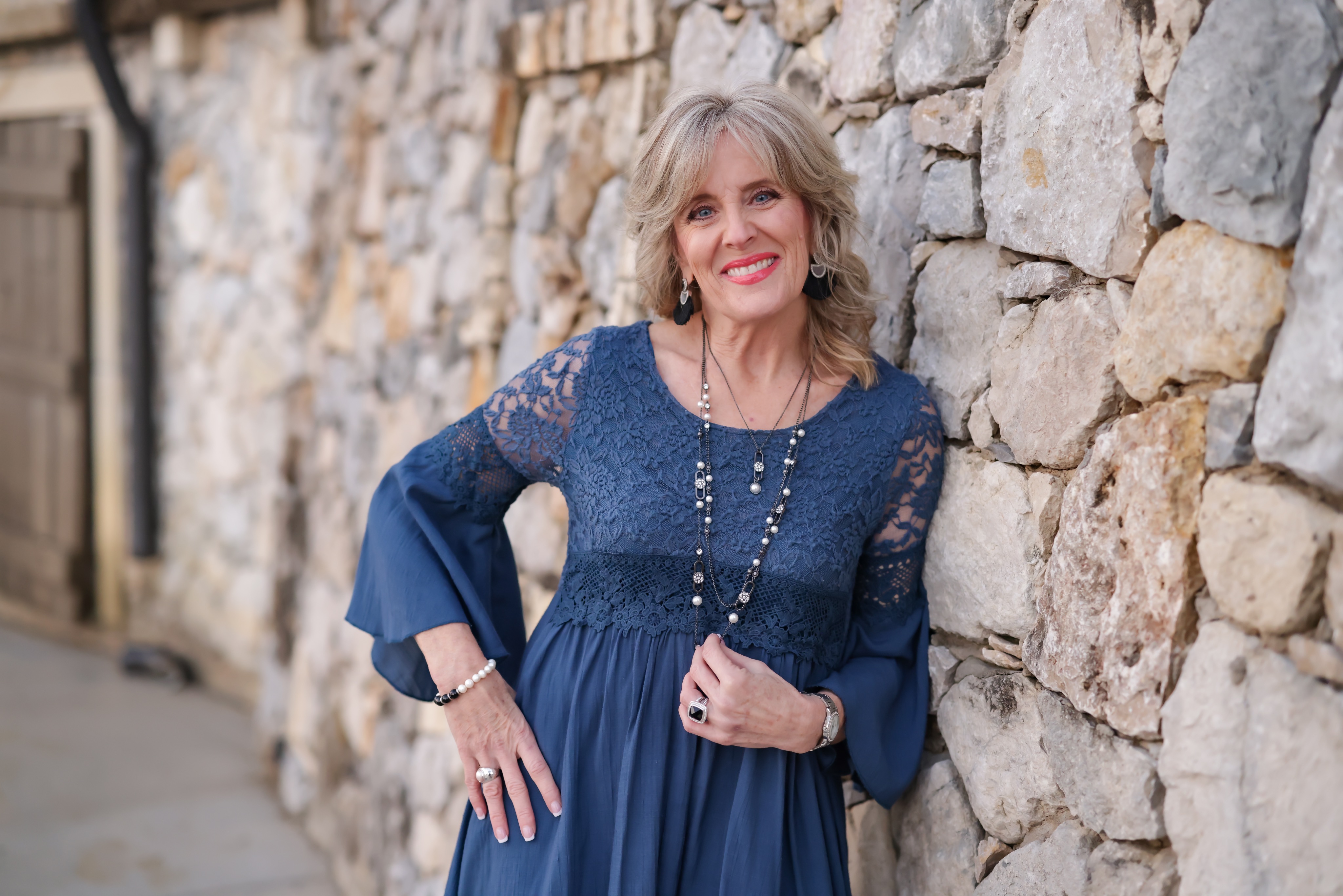 short-haired black cat besides brown wooden table