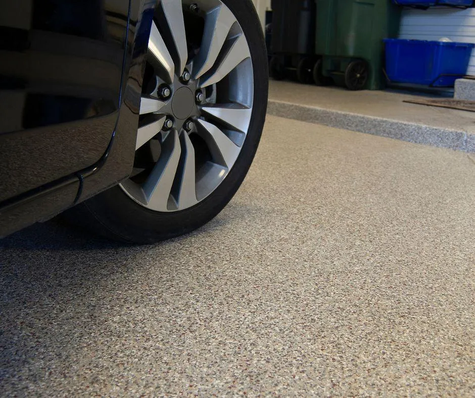 Garage floor with car parked, showcasing smooth and durable floor coating solution by VistaPro