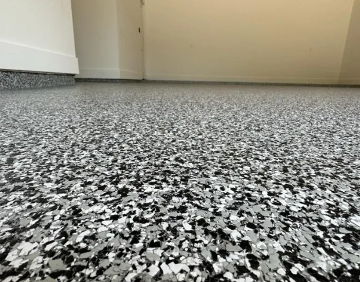 Close-up of durable epoxy garage floor coating with a speckled finish in DFW Metroplex home