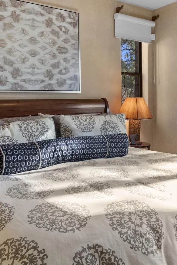 woman setting sheets on bed