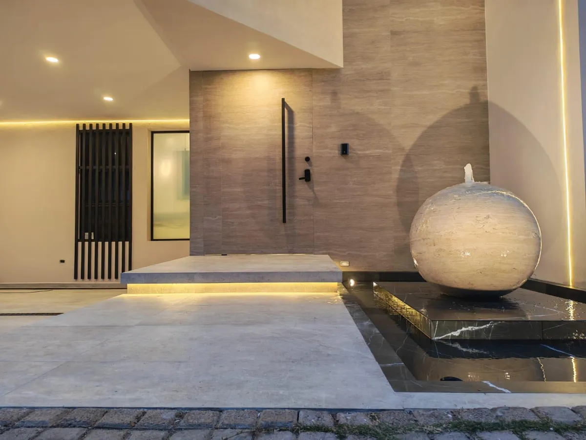 Modern living room with stylish furniture and shelving.