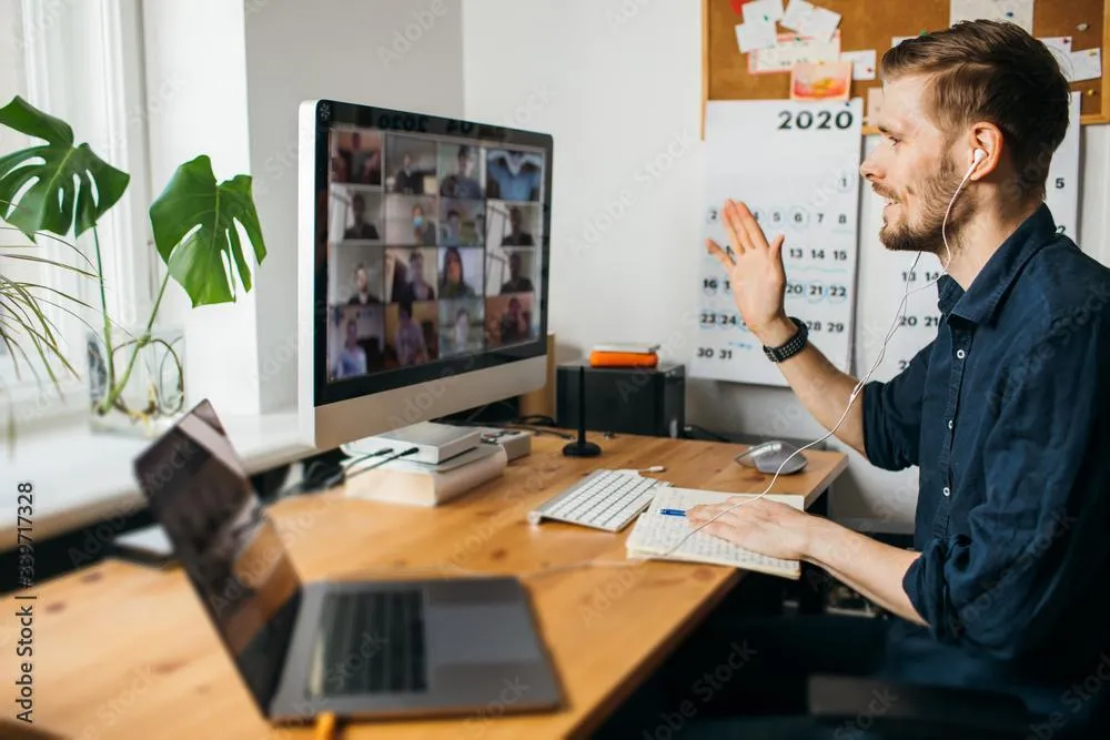 Image of a man on a zoom all with other participants having a conversation