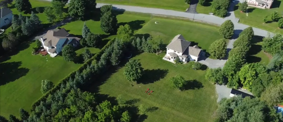 An aerial view of the green, tree-lined streets near Riding View in Stittsville