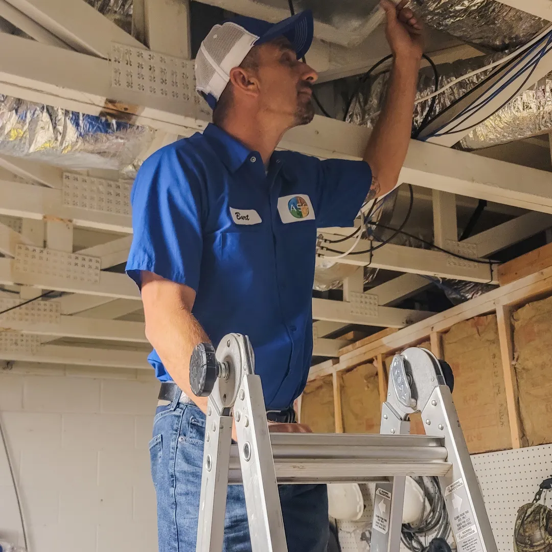 boy in blue crew neck t-shirt pouring water on clear glass mug