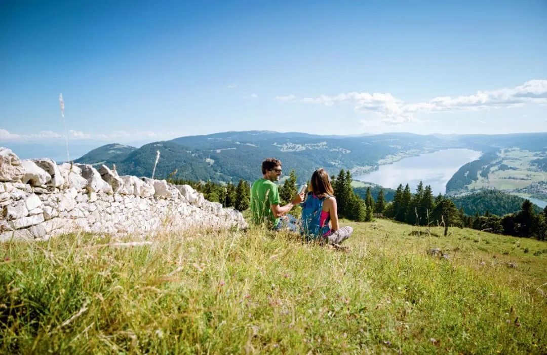 Family hiking near Lac de Joux with mountain views in summer