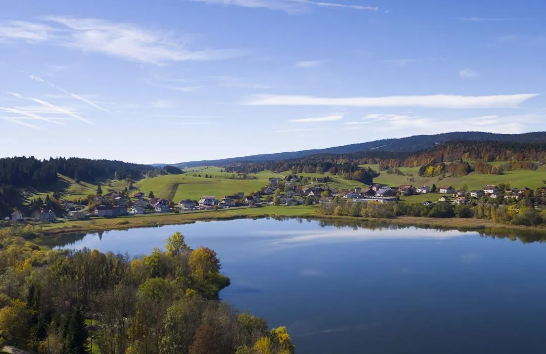 Summer view of Lac de Joux and Brenet with walking trails and forest