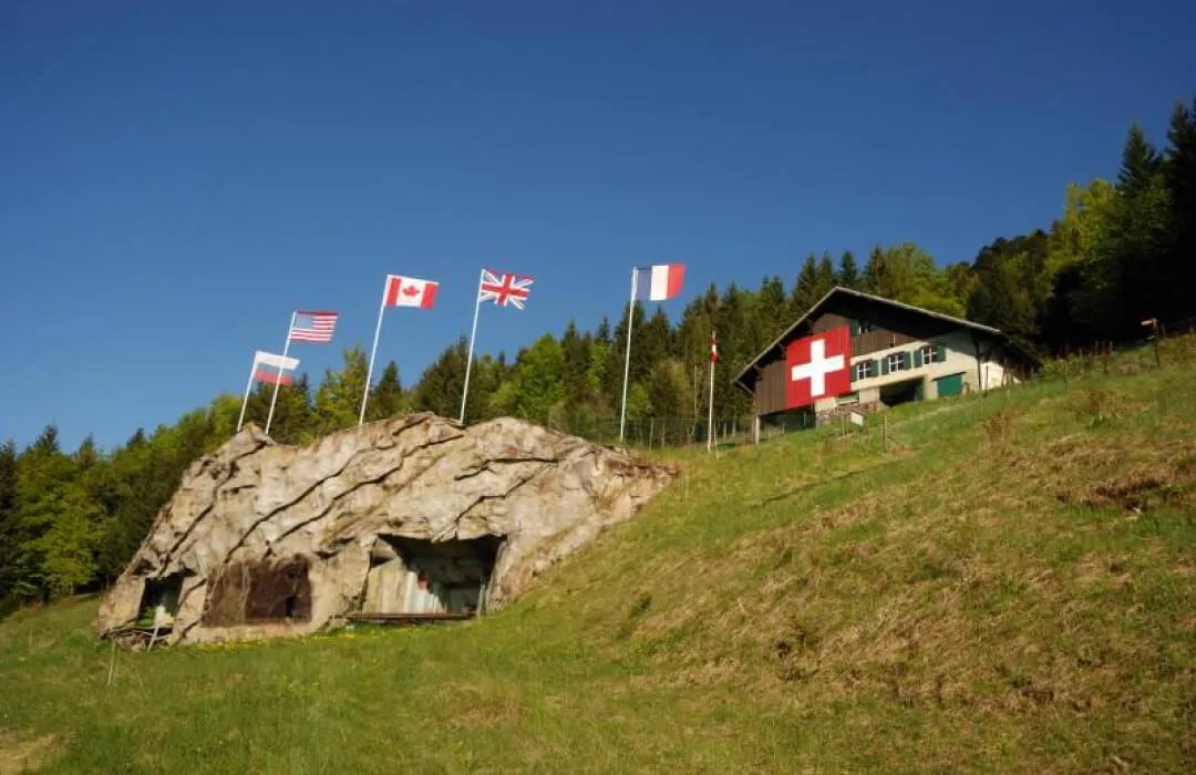 Fort de Pré-Giroud with camouflage bunker and flags in the Jura Vaudois