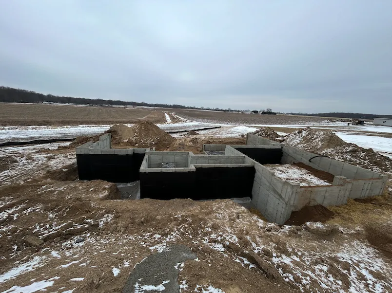 Residential concrete foundation under construction during winter