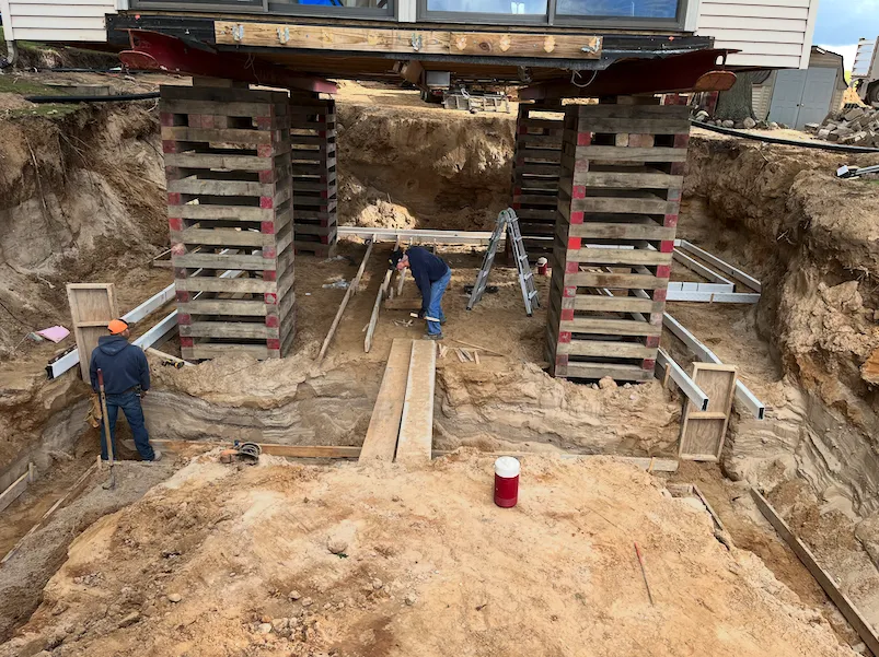 Residential foundation work beneath an elevated home