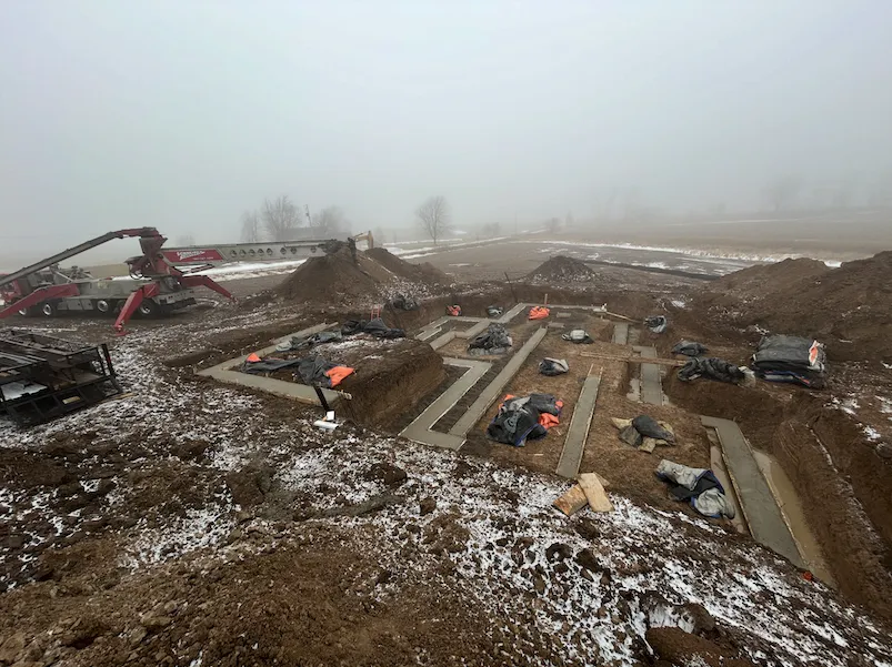 Large residential foundation project under construction in cold weather