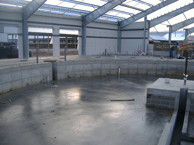 Finished concrete floor and foundation walls inside a farm building