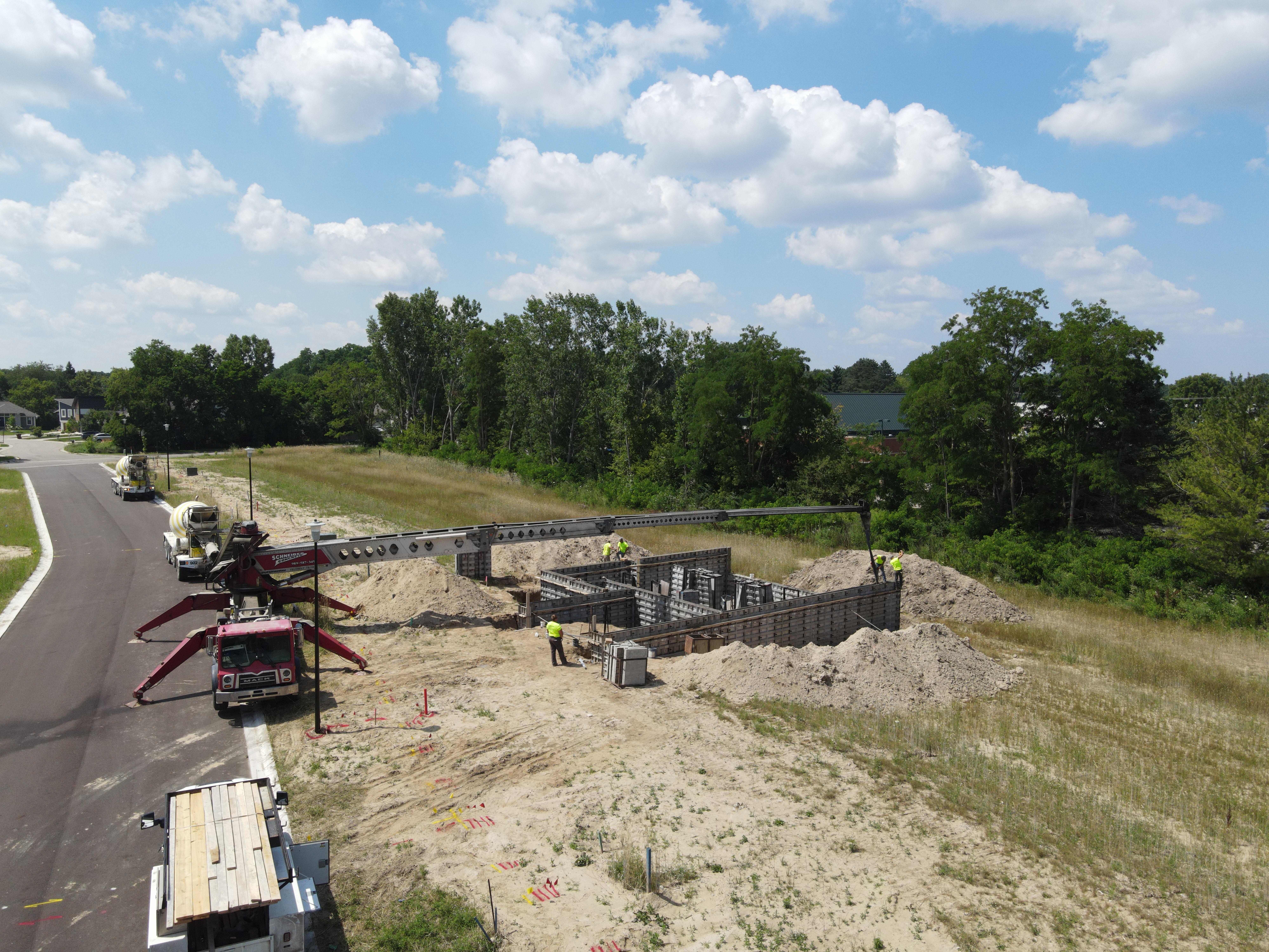 Crew working on residential foundation during the day
