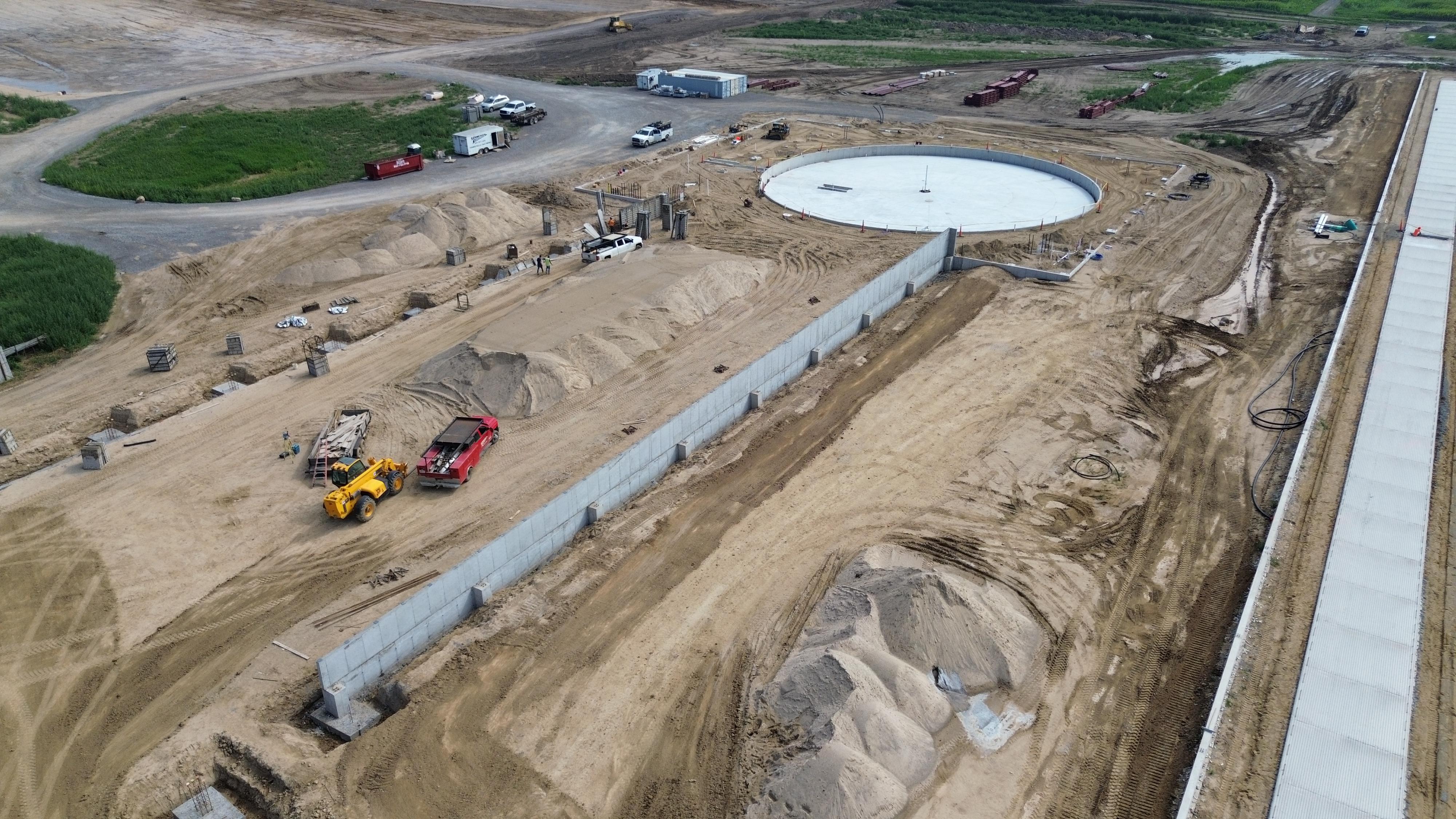 Expansive agricultural concrete project with crew on site