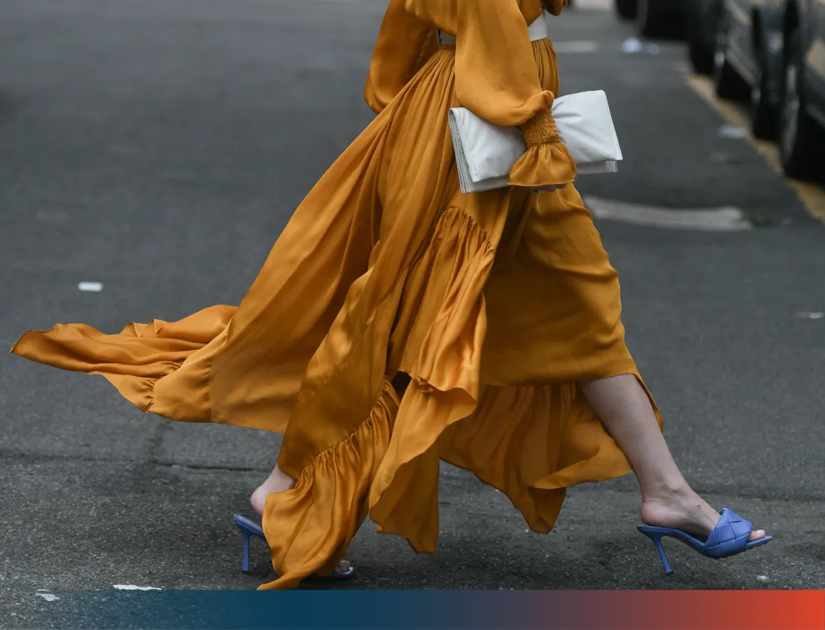 Woman in a dress walking down the street