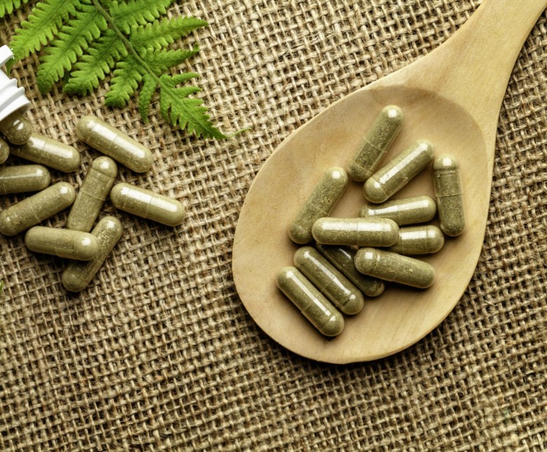 Herbal supplement bottles on a natural background