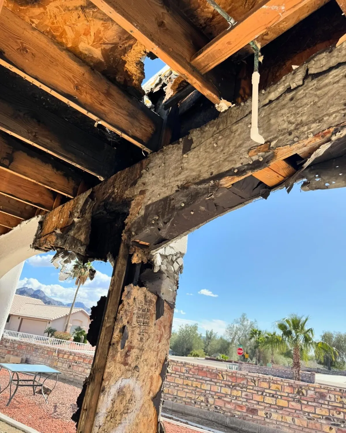 A close-up view of a severely damaged wooden patio