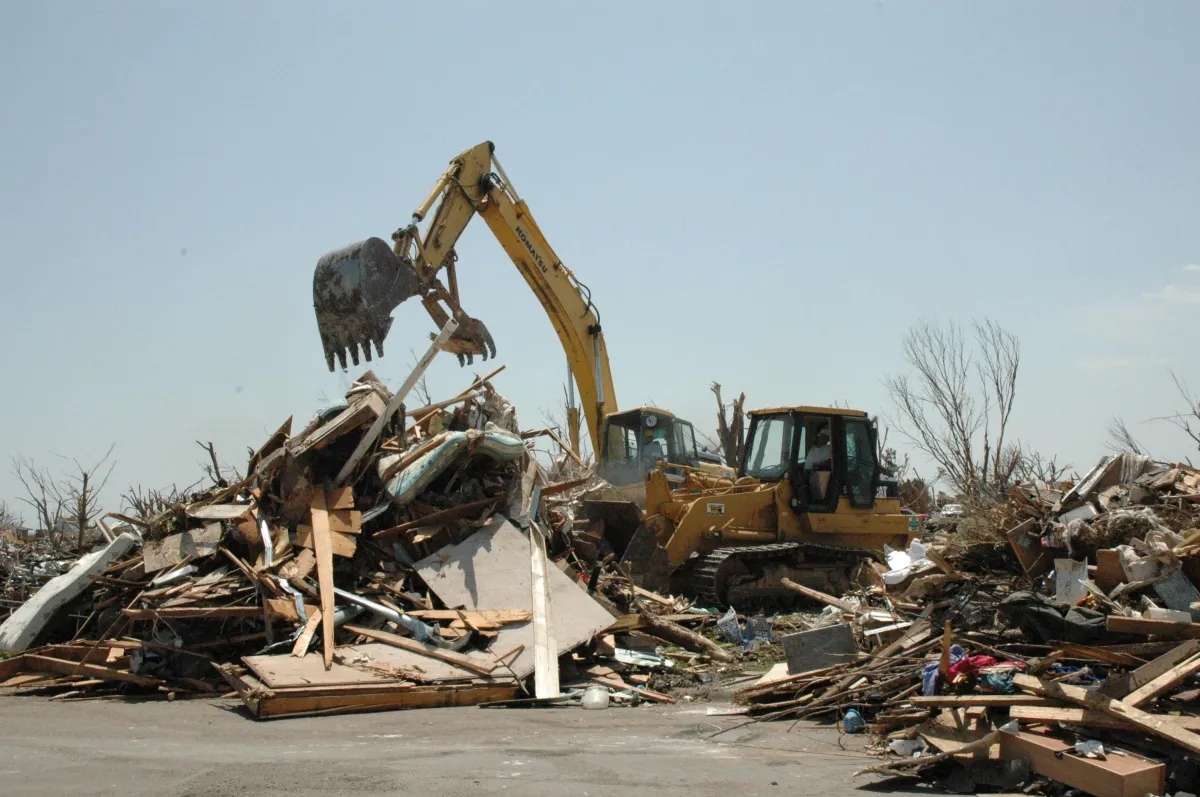 a construction equipment in a pile of debris