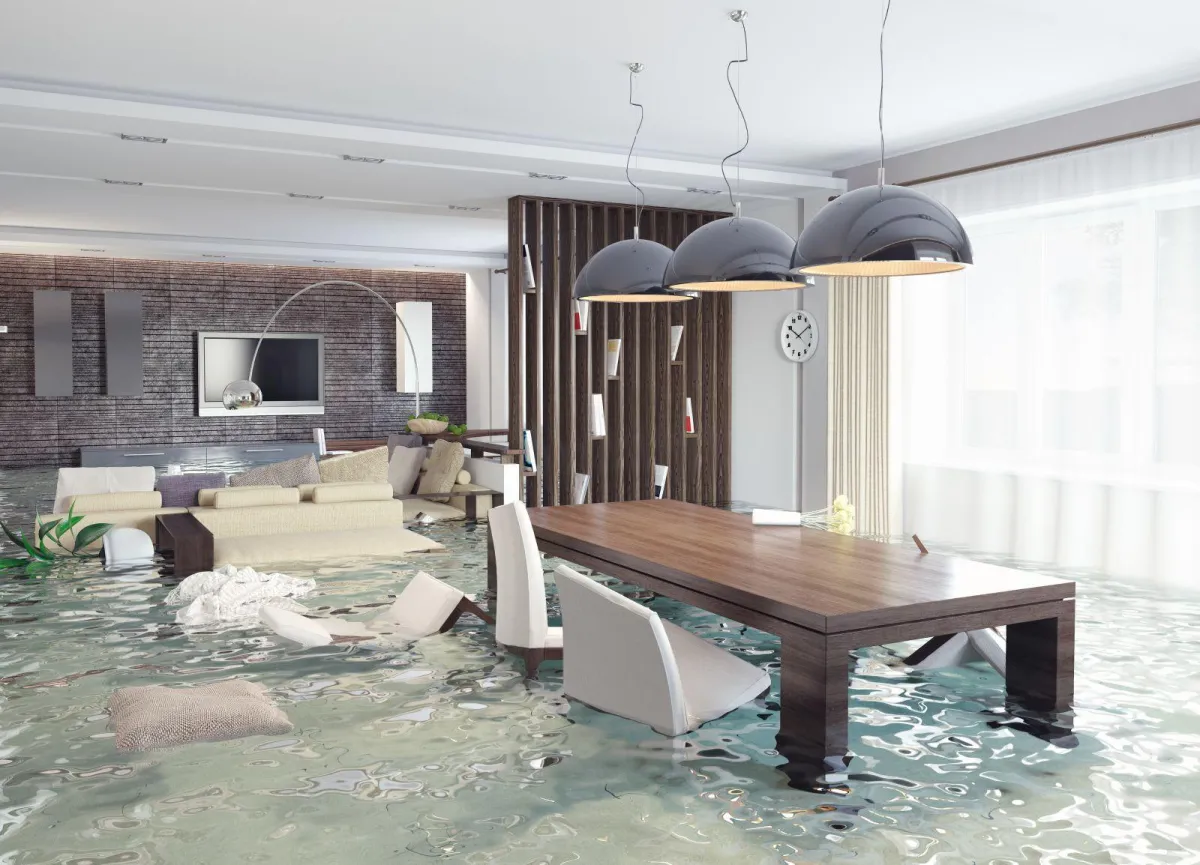 a flooded living room with a table and chairs