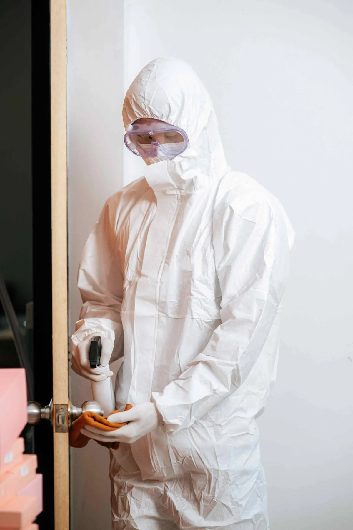 Person wearing a protective white suit with a hood