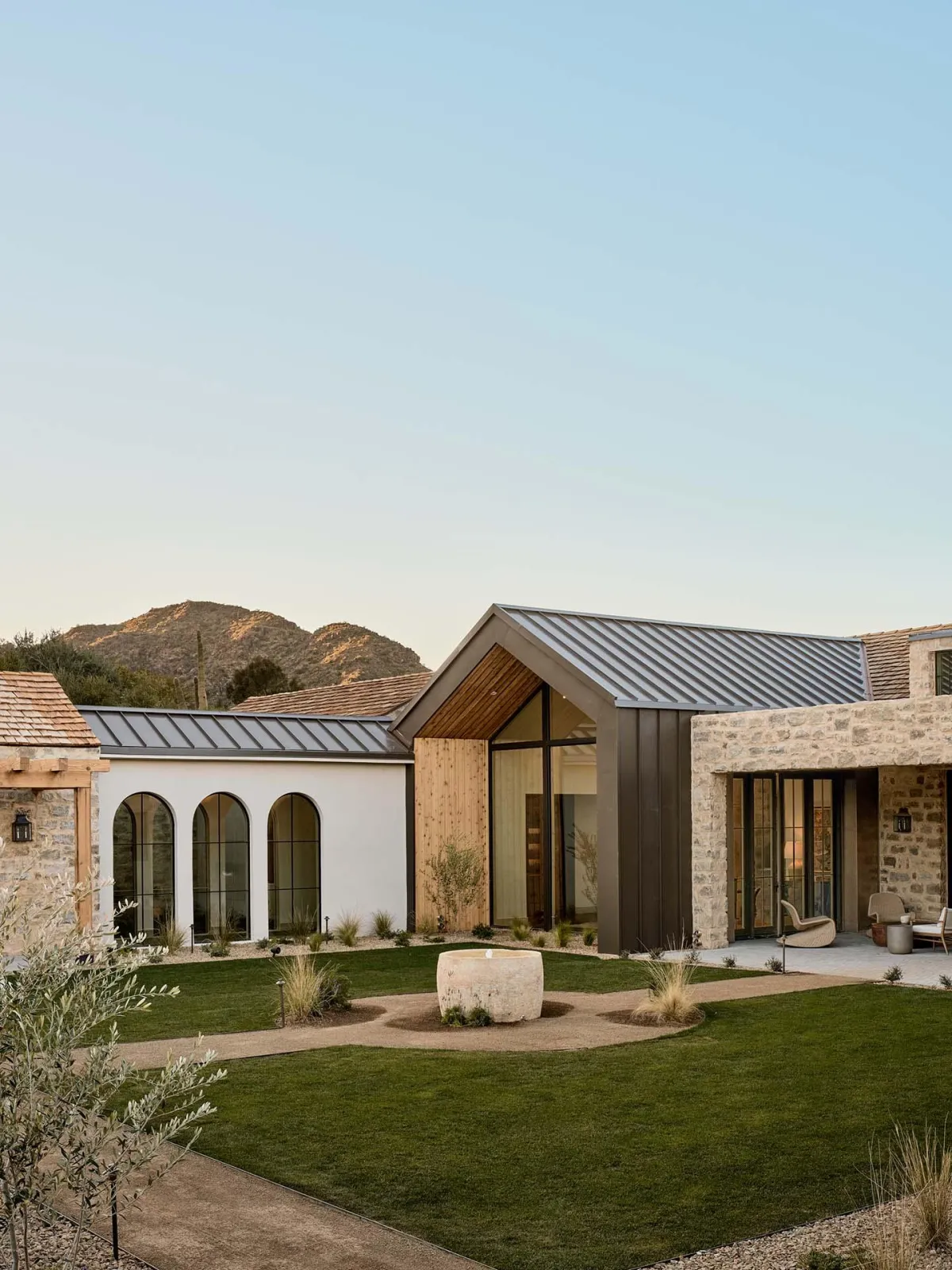 a new home with a mix of stone, wood, and metal finishes