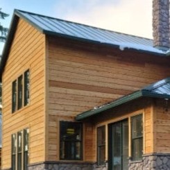 A circular image of a home with wood siding that links to the Siding page