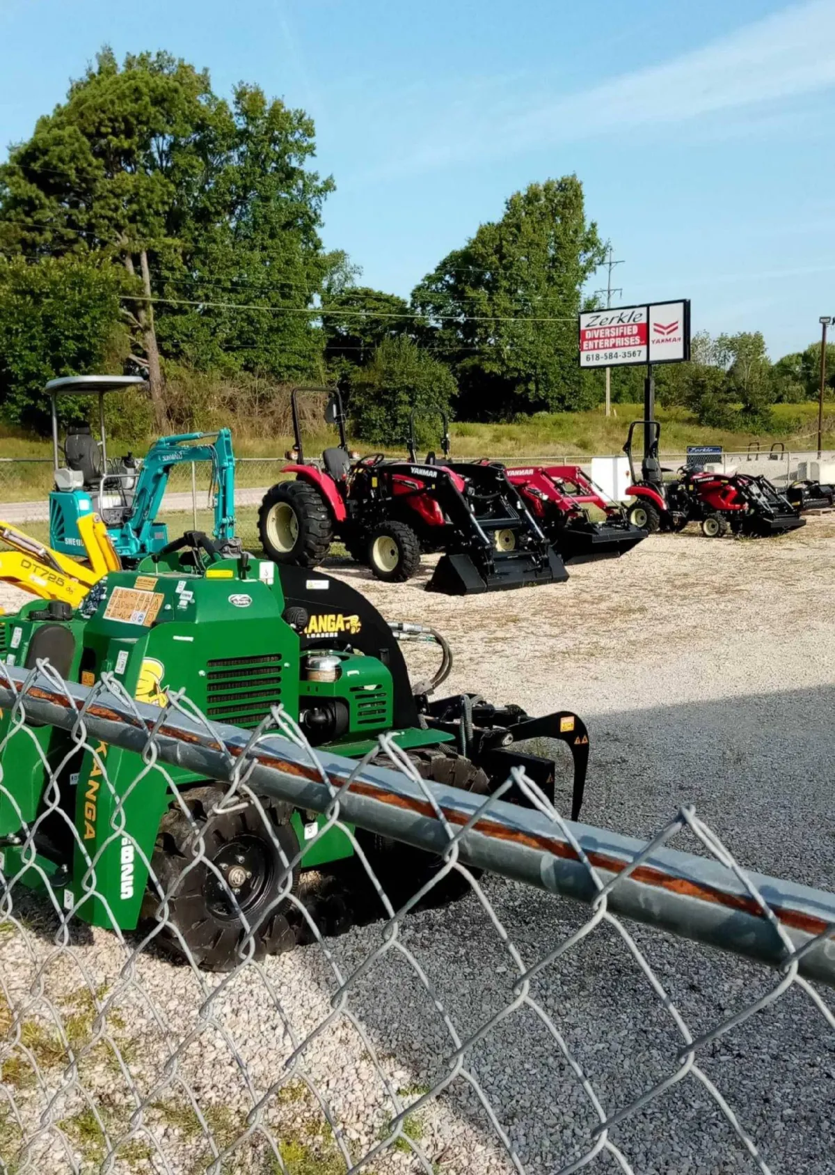 Zerkle Diversified Enterprises equipment lot with Kanga loaders, compact excavators and red tractors