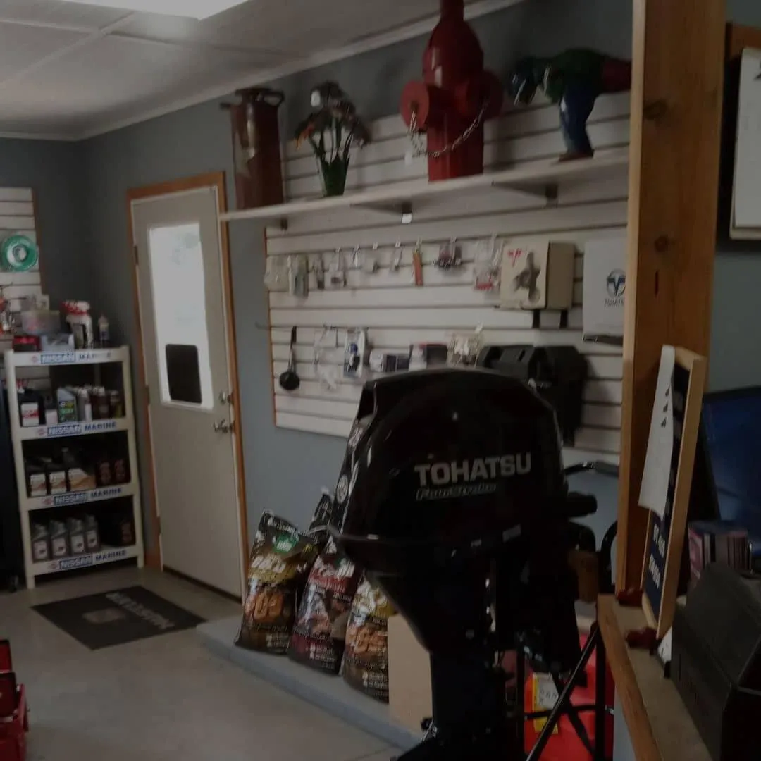 Store interior at ZD Enterprises showcasing shelves and an outboard motor, emphasizing world's largest Cuyuna parts source